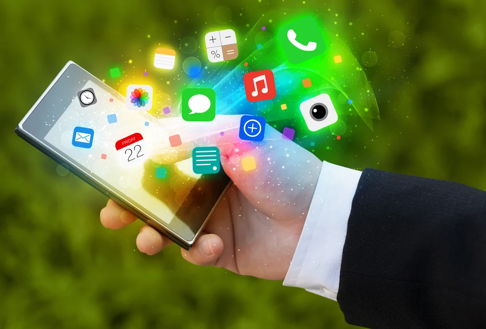 Hand holding smartphone with colorful app icons concept